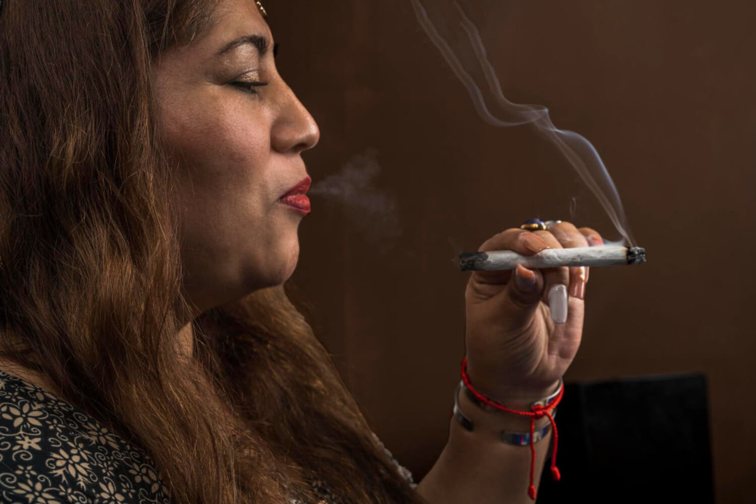 woman smokes pre-roll